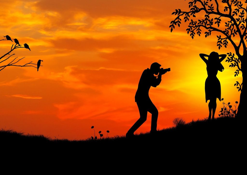 photographer taking pictures at sunset in photography skill.